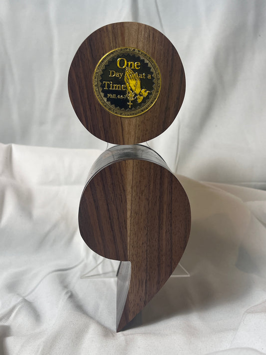 A black walnut semicolon keepsake box with a gold and black "One Day at a Time" coin embedded on the top.